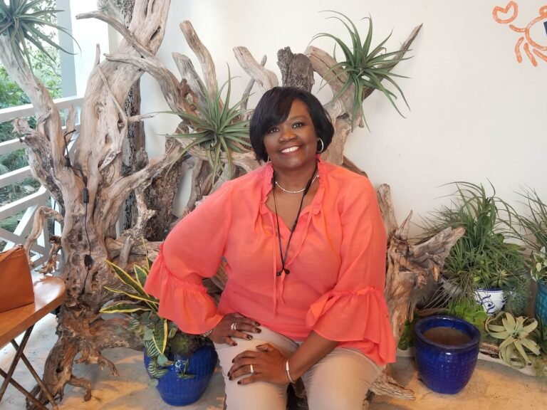Pam surrounded by plants